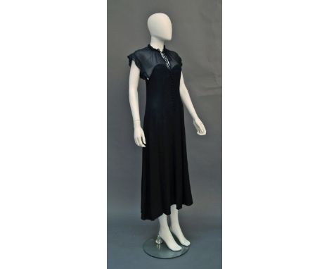 A Radley black crepe and chiffon dress, 1960s, the chiffon yoke with frilled detail to tie neck and arm holes, with covered b