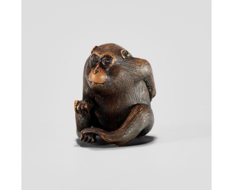 KAZUMASA: A WOOD NETSUKE OF A MONKEY PICKING FLEASBy Kazumasa (Issei), signed Kazumasa 一政Japan, 19th century, Edo period (161