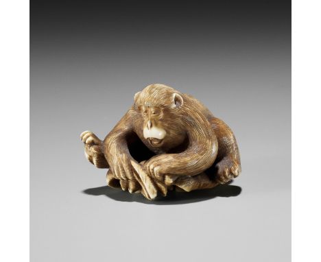 AN IVORY NETSUKE OF A MONKEY, CRAB AND LOTUSUnsignedJapan, Tokyo, late 19th centuryThe two arch enemies locked into combat, t