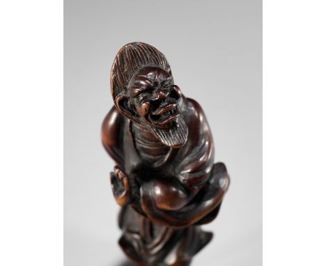 A RARE WOOD NETSUKE OF AN IMMORTALUnsigned Japan, 18th century, Edo period (1615-1868)Boldly carved to depict a Chinese immor