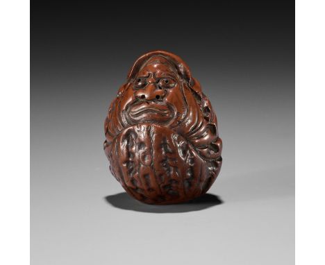 HIDARI ISSAN: A KURUMI (WALNUT) NETSUKE OF A ROLY POLY DARUMABy Hidari Issan, signed Hidari Issan 左一山Japan, Iwashiro Province