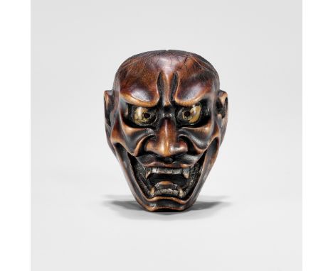 A WOOD MASK NETSUKE OF A FEMALE DEMONUnsignedJapan, late 19th centuryDepicting a female demon mask with menacing expression, 