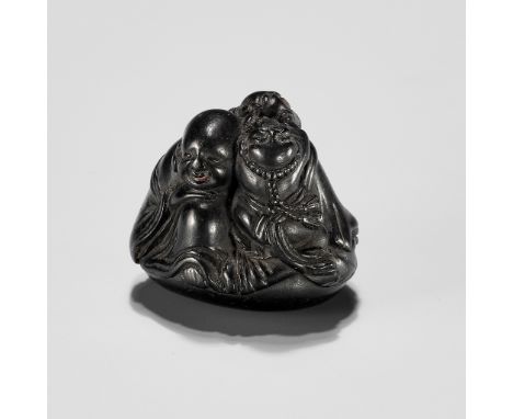 UNSHOKEN: A KUROGAKI NETSUKE DEPICTING HOTEI AND TWO BOYSBy Unshoken, signed Unshoken 雲生軒 with sealJapan, 18th century, Edo p