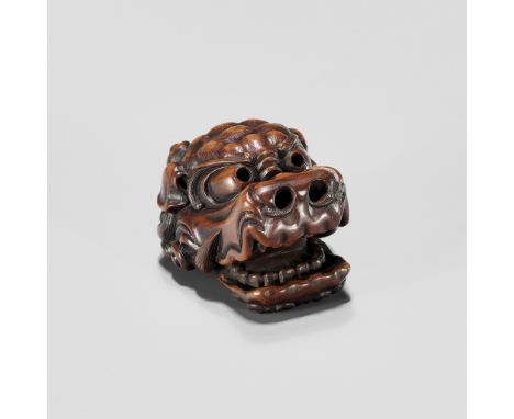 A WOOD NETSUKE OF A SHISHI MASK WITH MOVABLE JAWUnsignedJapan, 19th century, Edo period (1615-1868)Finely and expressively ca