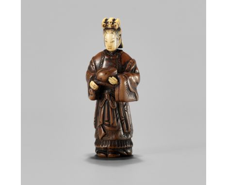 AN INLAID WOOD NETSUKE OF SEIOBO WITH THE PEACH OF IMMORTALITYUnsignedJapan, c. 1800, Edo period (1615-1868)The Queen Mother 