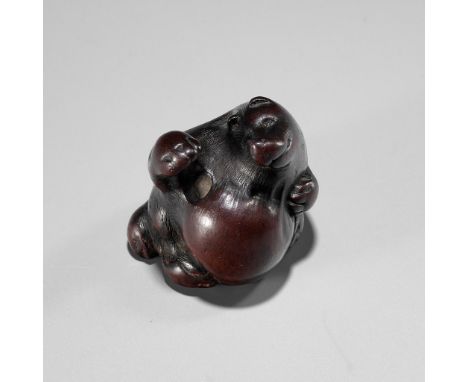 ITTAN: A WOOD NETSUKE DEPICTING TANUKI NO HARA TSUZUMIBy Ittan, signed Ittan 一旦 with kakihanJapan, Nagoya, first half of 19th