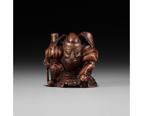 A WOOD NETSUKE OF SHOKI TRAPPING AN ONIUnsignedJapan, 19th century, Edo period (1615-1868)The demon queller shown here with a
