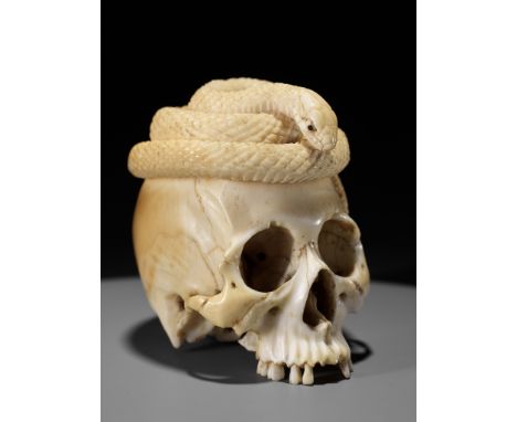 A SUPERB IVORY OKIMONO OF A SKULL WITH SNAKE AND LOTUSUnsignedJapan, Tokyo, Meiji period (1868-1912)A morbidly fascinating iv