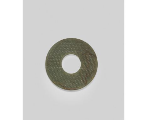 AN ARCHAIC GREEN AND RUSSET JADE DISC, BIWarring States Period/Han DynastyEach side carved in low relief with 'comma' spirals