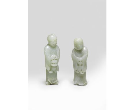 A PAIR OF PALE GREEN JADE FIGURES OF THE HEHE ERXIAN17th century Each carved standing holding a basket with lingzhi and a str