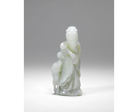 A PALE GREEN JADE FIGURE OF A SAGE AND DEER18th centuryDeftly carved as a bearded sage in long flowing robes clasping a ruyi 