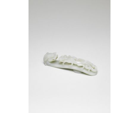 A VERY PALE GREEN JADE BELT HOOKMid Qing DynastyThe terminal deftly carved in high relief with a twin-horned dragon head, wit