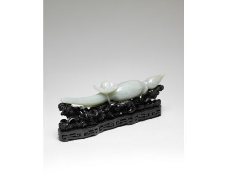 A LARGE PALE GREEN JADE 'LOTUS-ROOT' CARVING18th century The stone naturalistically carved as a long root, the rhizome finely