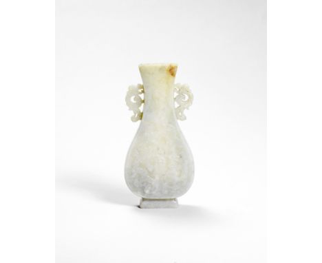 AN ARCHAISTIC PALE GREEN JADE VASELate Ming DynastyThe flat pear-shaped vase carved on both sides in low relief with two arch