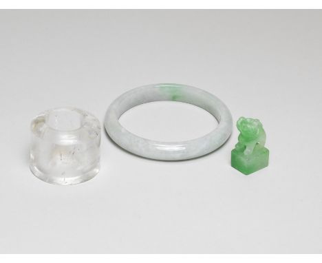 A JADEITE BANGLE, A SEAL AND A ROCK CRYSTAL THUMB RINGQing DynastyThe jadeite bangle smoothly carved, the stone of pale-green