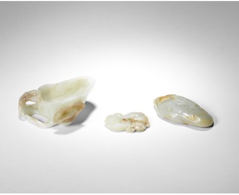THREE JADE SCHOLAR'S OBJECTSComprising a pale green and chestnut brown 'lotus' washer, Song/Ming dynasty, carved as a concave
