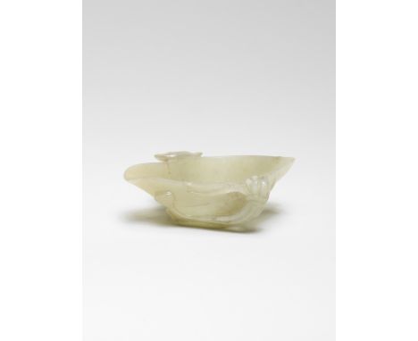 A PALE GREEN JADE 'LOTUS' CUPMing Dynasty Finely carved as a lotus leaf borne on a stem tied with a string on the side to oth