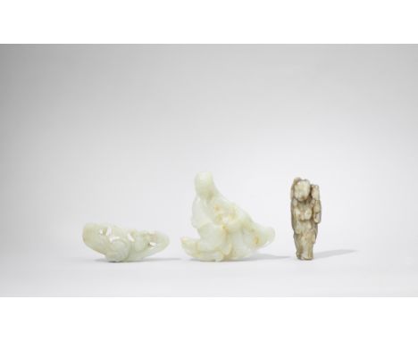 THREE JADE CARVINGSComprising a seated sage with beard, 18th century, clad in loose flowing robes, the jade of pale green ton