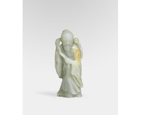 A PALE GREEN JADE FIGURE OF SHOULAO18th century  The figure gracefully carved standing with his arms raised holding a gnarled