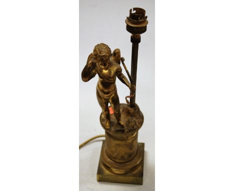 An early 20th century gilt metal table lamp, surmounted by a figure of Cupid with his bow, on column base (Cupid lacking arro