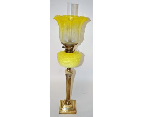 A Victorian oil lamp, having yellow tinted frilled glass shade above yellow glass font, to a brass Corinthian column pedestal