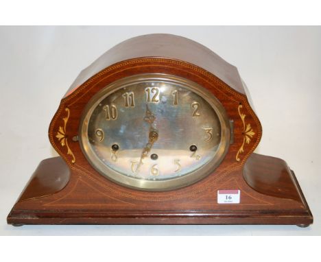 A circa 1900 mahogany and inlaid mantel clock having Art Nouveau influenced silver dial, and with striking and chiming moveme
