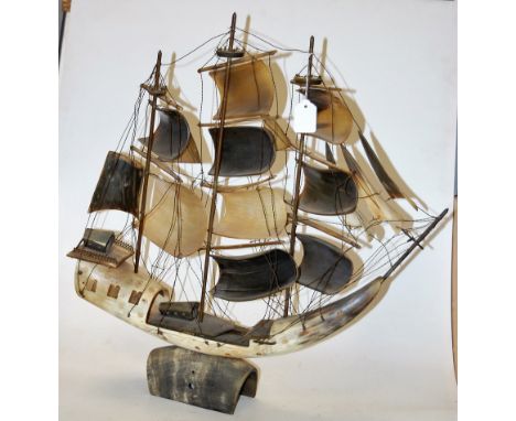 An early 20th century carved horn model of a three-masted frigate, h.60cm