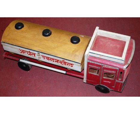 A wooden scratch built model of a public carrier, highly inflammable tanker, finished in wood and hand painted in red and whi