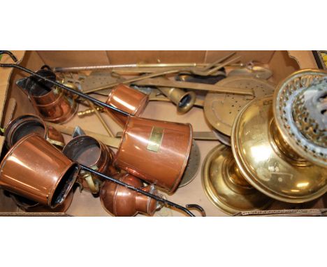 A box of miscellaneous metalwares to include copper cider measures, brass oil lamp, brass chestnut roaster, fire tools etc