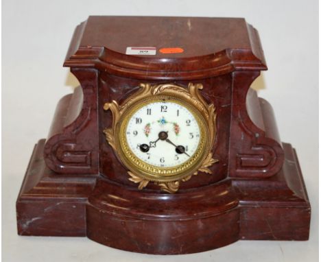 An early 20th century Continental rouge marble cased serpentine shaped mantel clock, having enamelled dial with Arabic numera