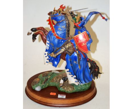 A Franklin Mint ceramic model of a knight on rearing horse on wooden plinth, height 42cm