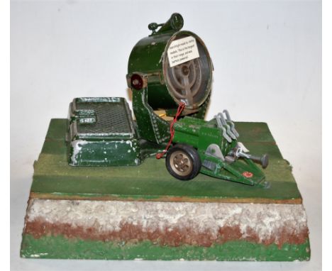 An Astra Models battery powered military type searchlight together with an Astra toys green painted model of a canon with gre