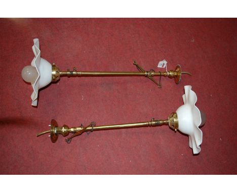 A pair of brass adjustable ceiling light fittings with opalescent frilled glass shades