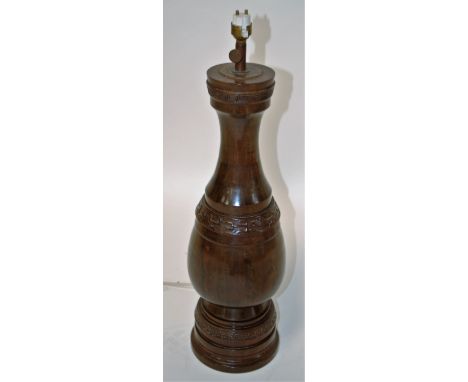 A turned and polished walnut ? table lamp, wired for electricity, lacking shade, 50cm