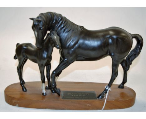 A Beswick Connoisseur model 'Black Beauty and Foal' on wooden plinth