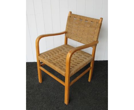 A beech framed armchair with seagrass seat and back