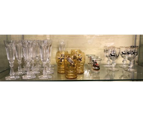 SHELF OF PANELLED FLUTES, SET OF SIX AMBER TUMBLERS DECORATED WITH WILD FOWL AND SMALL WINE GLASSES BY JOSEPH LENHARDT