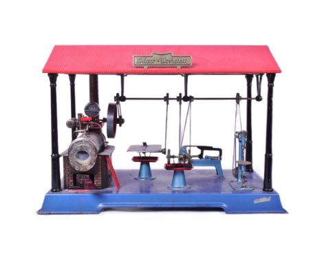 An original Wilesco D141 live steam engine workshop. Horizontal steam engine with pressure gauge, single cylinder and brick e