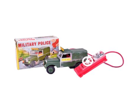 A vintage Louis Marx (Hong Kong) battery operated remote control Military Police Land Rover. Boxed and with a clean battery c