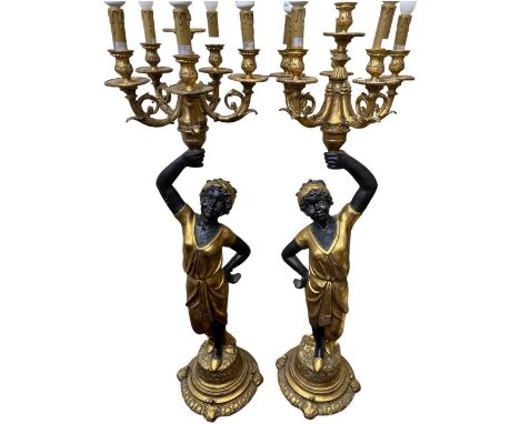 A Pair of Blackamoor Freestanding 6 Arm Candelabra. Gilded candelabra and base and figure in gilded dress. Of resin formHeigh