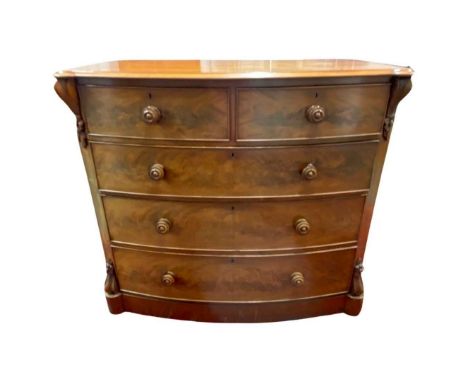 2 Over 3 Bow Fronted Early 19th Century Chest of Drawers. In light mahogany with carved supports to the side.Provenance: The 