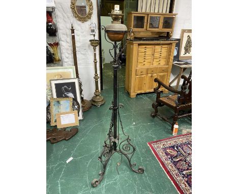 A Wrought Iron Oil Lamp Stand converted to Electric stands on tripod feet with typical scrolling iron workHeight to top of li
