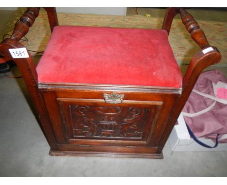 An Edwardian piano stool with drop down front.