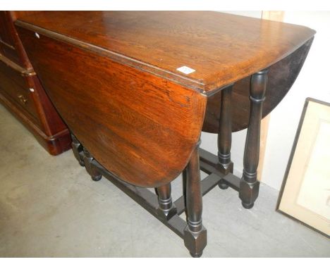 A 1930's oak gate leg table.