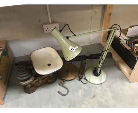 A set of scales, angle poise lamp and weed flame wand