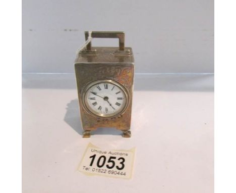 A hall marked silver miniature carriage clock with French movement, in working order. ****Condition report**** Fair to good c