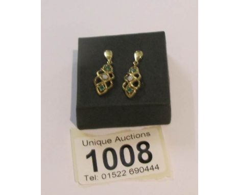 A pair of 9ct gold earrings set  opal and peridot.