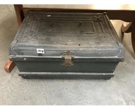 An ornate vintage metal travel trunk