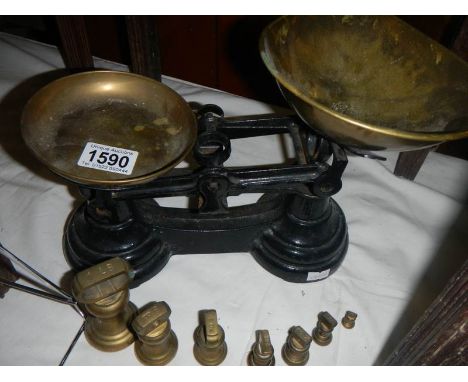 A set of scales with brass weights.