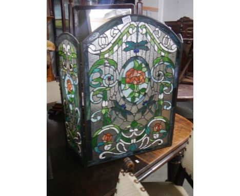 A Tiffany style glass fire screen